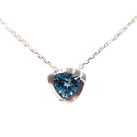 triangle shaped blue topaz sterling silver pendant with a silver chain made for Michael's Custom Jewelers in Provincetown